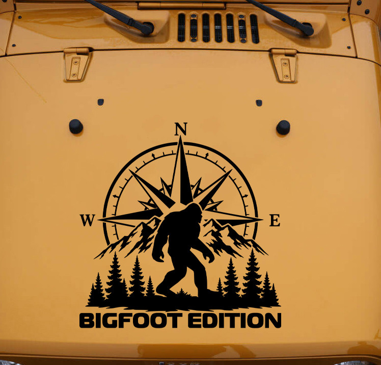 Bigfoot Edition vinyl decal with Sasquatch compass rose mountains and evergreen trees displayed on a truck window