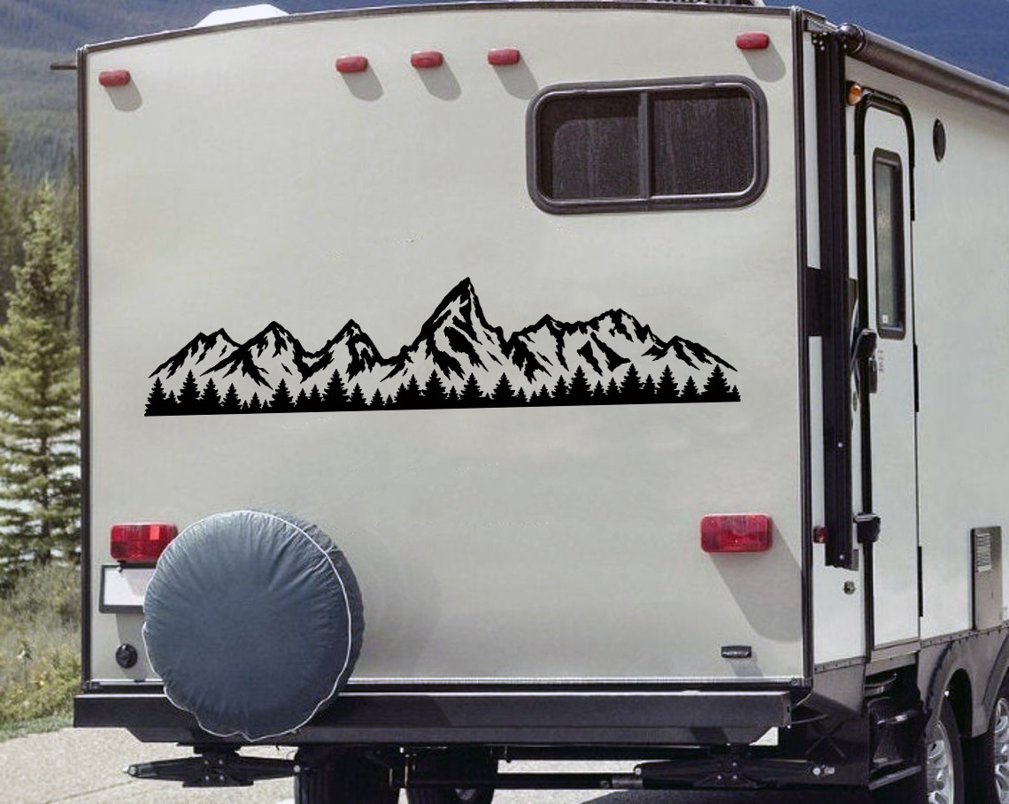 Grand Tetons vinyl decal with rugged mountain peaks and evergreen pine forest displayed on an RV camper exterior panel