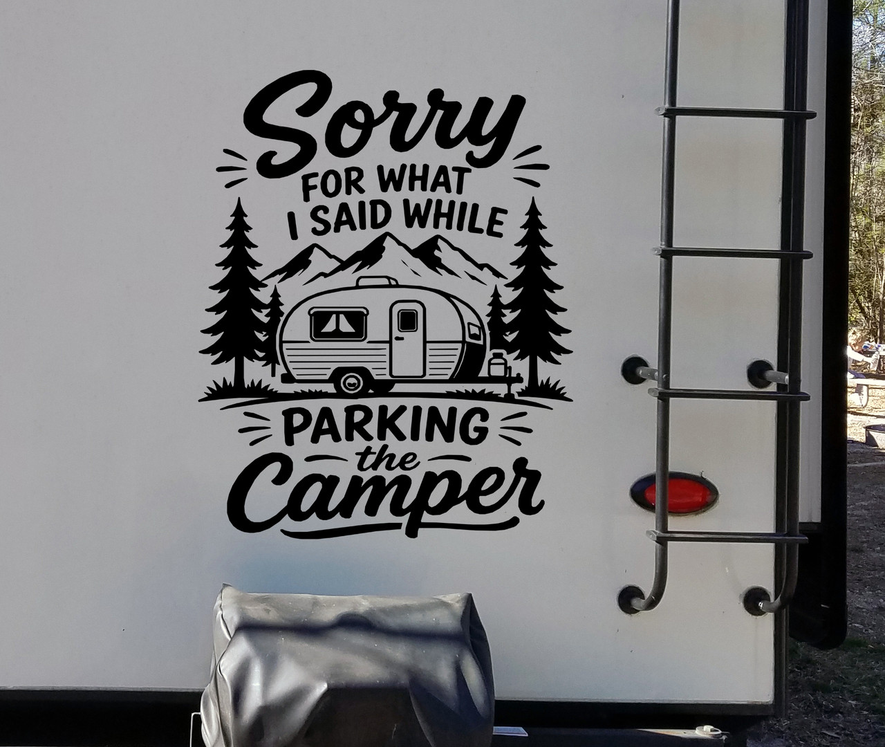 Sorry For What I Said While Parking the Camper vinyl decal featuring a travel trailer, mountains and pine trees on a camper exterior
