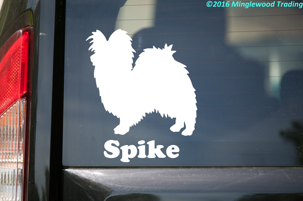 Personalized Papillon Butterfly Dog silhouette vinyl decal with custom name underneath, shown with the name Spike on a vehicle window, available in six sizes from 4 x 4.5 inches to 20 x 23 inches with mirror option and 15-character name personalization