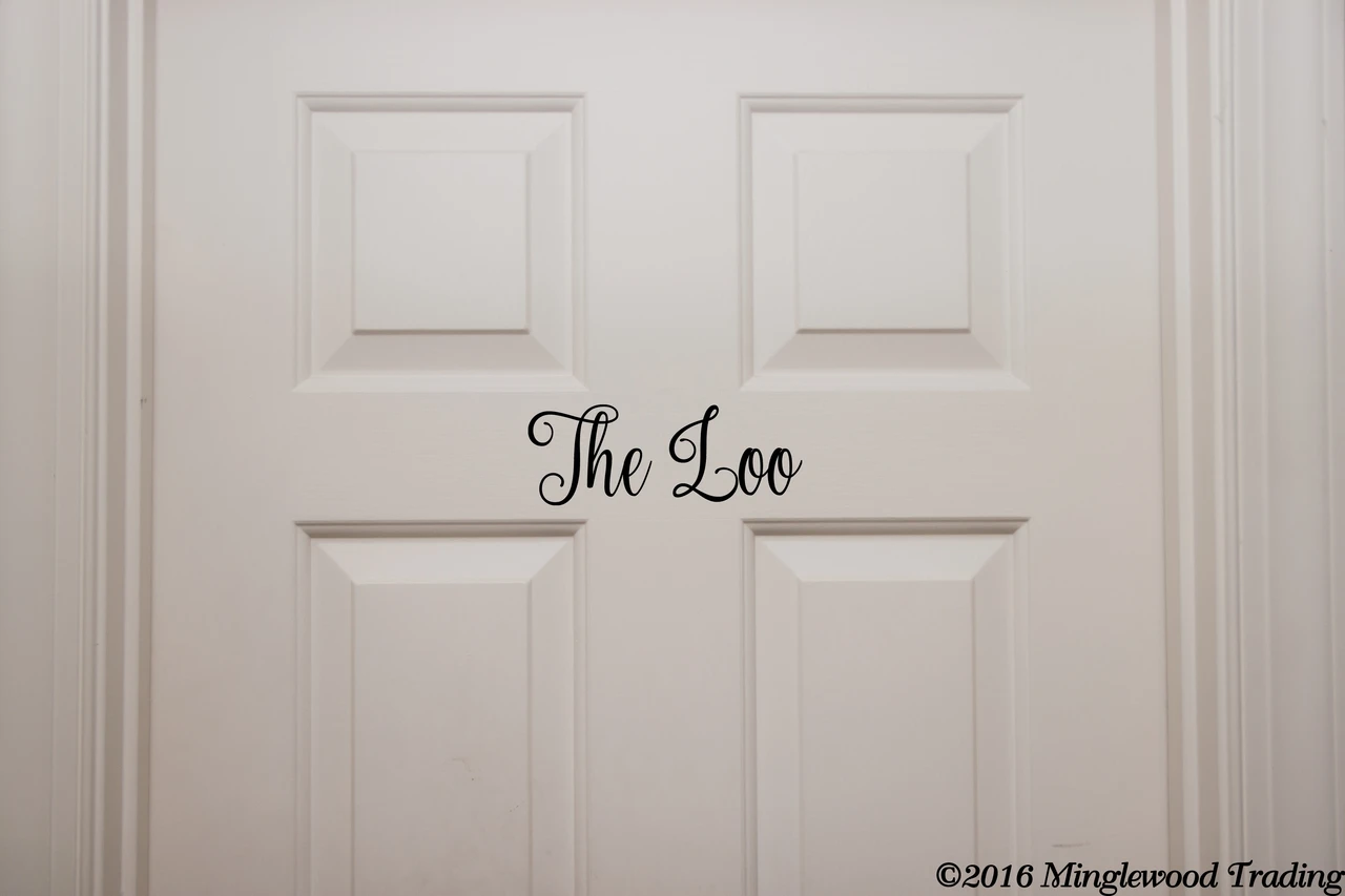 The Loo bathroom door vinyl decal featuring elegant Nouradilla cursive script lettering, available in seven sizes from 5.5 x 2 inches to 27 x 10 inches for restroom doors, powder rooms and bathroom decor