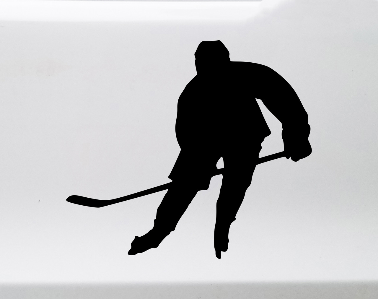 Ice hockey player skating vinyl decal silhouette with hockey stick