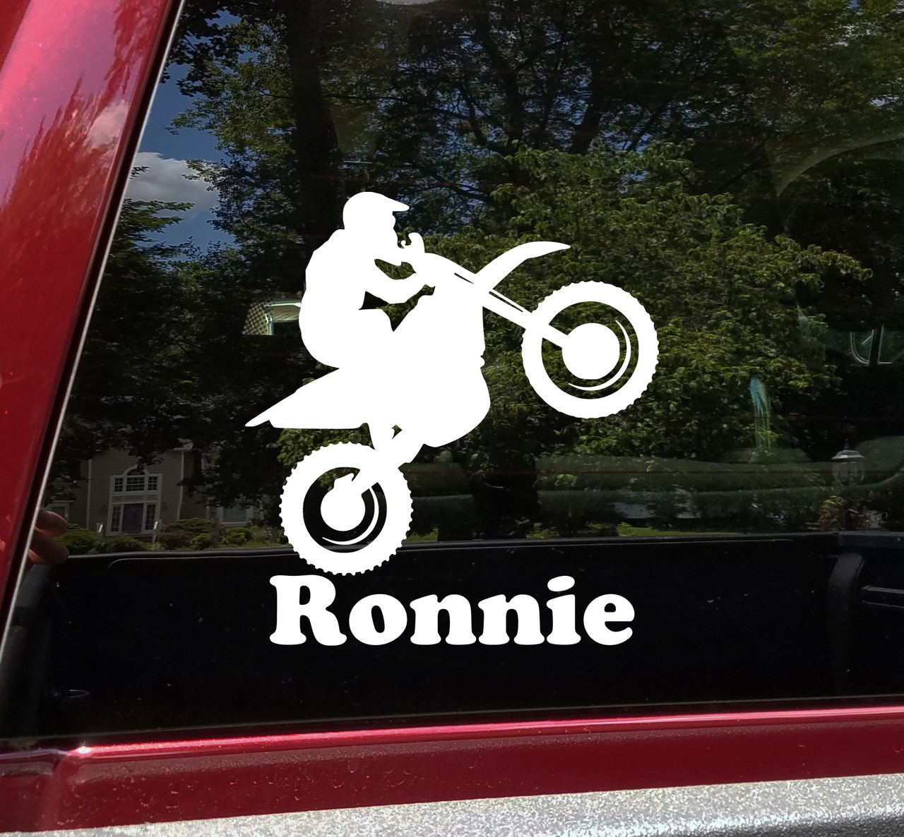 Personalized dirt bike vinyl decal featuring motocross rider doing a wheelie with custom name and racing number