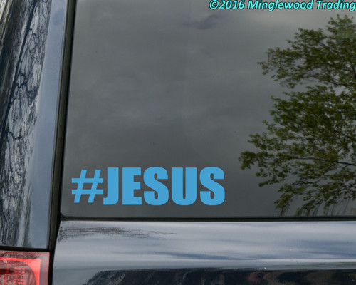 #JESUS vinyl sticker decal with bold hashtag typography applied to car window with minimalist Christian design
