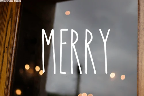 Merry Christmas vinyl decal featuring the word Merry in tall skinny farmhouse style handwritten lettering displayed on glass window