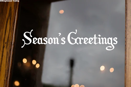 Season's Greetings Christmas vinyl decal in decorative Old English Gothic lettering displayed on glass window for holiday decorating
