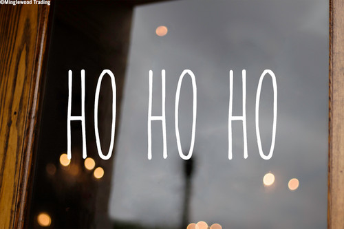 Ho Ho Ho Christmas vinyl decal featuring tall skinny farmhouse style lettering arranged horizontally on a glass window