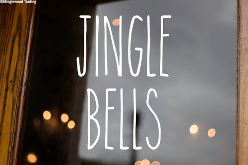 Jingle Bells Christmas vinyl decal featuring tall skinny farmhouse style handwritten lettering arranged in two lines on glass window