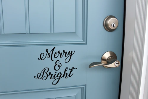 Merry and Bright Christmas vinyl decal with elegant script lettering displayed on front door for holiday decorating