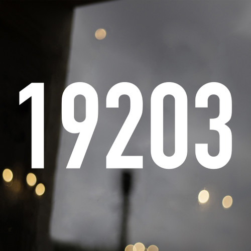 Large storefront address numbers vinyl decal in DIN 1451 font with modern minimalist business signage style