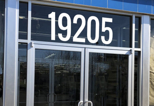 Large storefront address numbers vinyl decal in Oswald font with modern minimalist business signage style