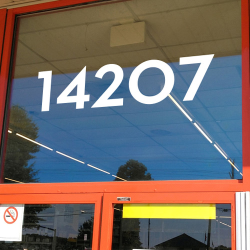 Neutra Display font storefront address numbers vinyl sticker decal applied to a business window with clean geometric lettering