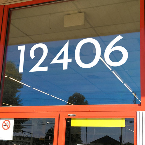 large Josefin Sans vinyl storefront numbers applied to modern business window with retro mid century typography