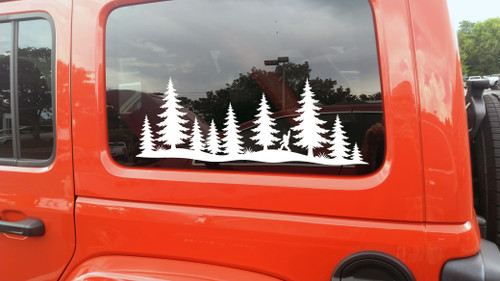 bigfoot sasquatch middle finger vinyl sticker decal with pine forest silhouette applied to rv camper rear window outdoors scene