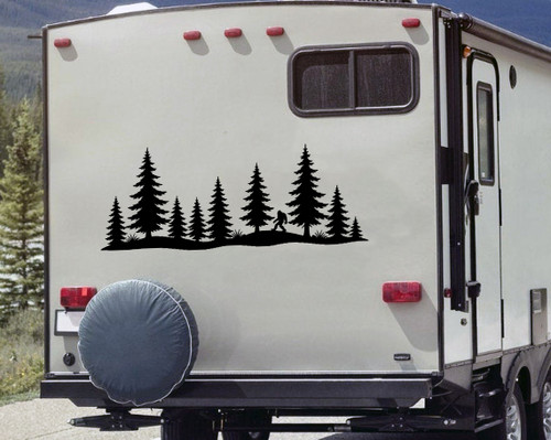 bigfoot sasquatch walking pine forest vinyl sticker decal applied to rv camper rear window with wilderness silhouette design