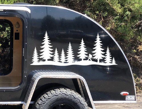 bigfoot sasquatch walking pine forest vinyl sticker decal applied to rv camper rear window with wilderness silhouette design