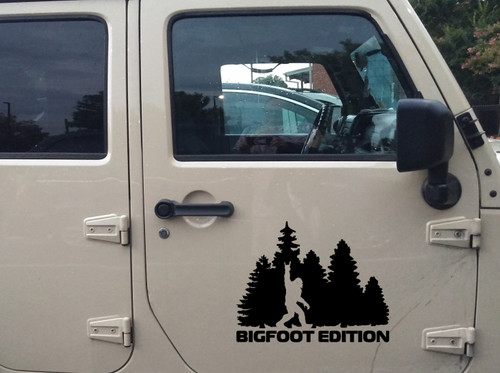 bigfoot edition forest vinyl sticker decal featuring sasquatch throwing metal horns while walking through pine trees