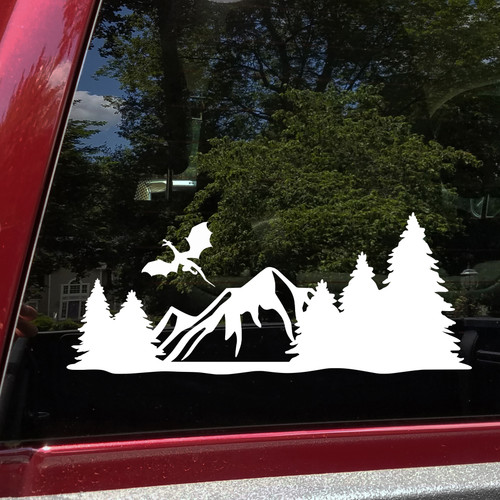 mountain dragon vinyl sticker decal featuring a flying dragon above rugged mountain peaks and pine forests designed for rvs campers travel trailers and teardrop campers
