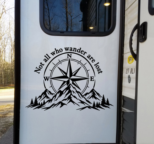 Not All Who Wander Are Lost vinyl decal featuring a compass rose, mountain range, and evergreen forest for RVs, campers, trucks, SUVs, travel trailers, and overland vehicles.