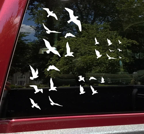 25 flying bird vinyl decal set arranged across Jeep doors and vehicle body panels