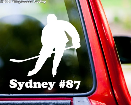 White personalized ice hockey player vinyl decal featuring a skater holding a hockey stick with custom name Sydney and jersey number 87 beneath the silhouette, displayed on a red truck window, available in four sizes with mirror option