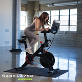 Woman on exercise bike with the BaseLayer Balance Active Tiles
