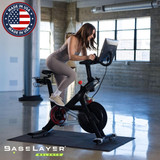 Woman on exercise bike with the BaseLayer Balance Active Tiles