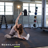 Woman stretching on the BaseLayer Core Active Tiles
