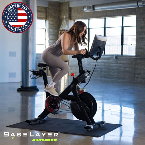 Woman on exercise bike with the BaseLayer Balance Active Tiles