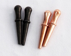 Four cribbage pegs:  two in black and two in copper.