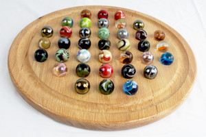 A Boulder sized Marble Solitaire game in oak with the marbles in their starting positions.