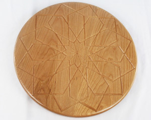 Top view of a lazy susan in cherry with a square rose design in the center.