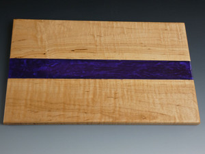 Maple Small Purple Charcuterie Serving Board #19
This is a solid curly maple charcuterie serving board filled in the center with tinted epoxy. The tint is called Purple Haze.

The board is about 7 ½” wide, 12” long, and 1/2” thick.

This was finished with food safe cutting board oil and a protective cutting board wax.