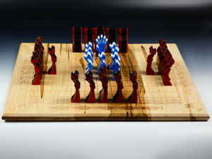 Hnefatafl board with the poured resin pieces in their starting positions.  The resin pieces are either white with blue or black with red.