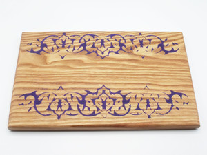 A small serving board in Kentucky coffeenut with a mirrored purple epoxy tribal design  along the long edges.