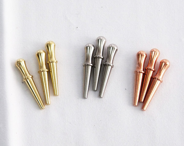 9 cribbage pegs in brass, steel, and copper.