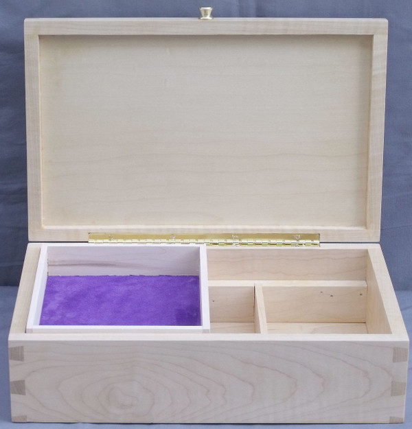 The curly maple valet box open with its lid resting upright on a solid brass stop-hinge, revealing a removable, unvarnished solid maple top tray lined with vibrant blue suede leather on the bottom.