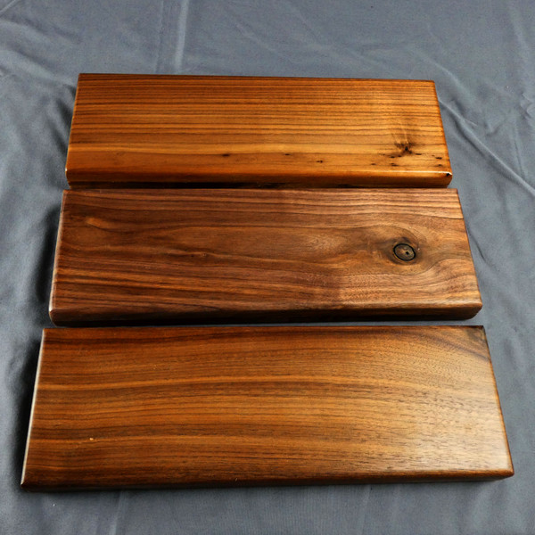 The backs of three Walnut 3 Player Cribbage board showing the variety of grain patterns and coloring.