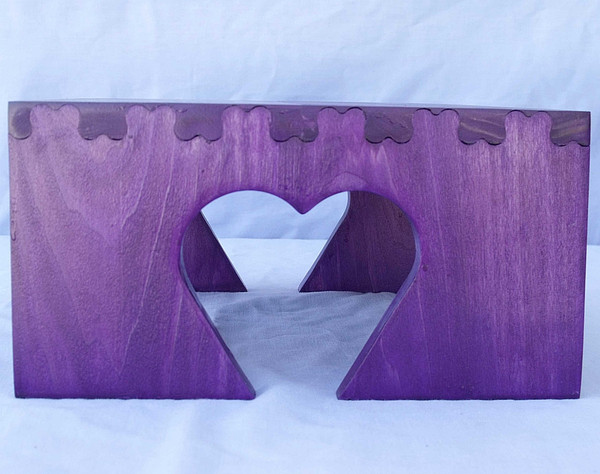 Side view of the step stool showing the heart cut out and the interlocking heart joinery that attaches the top and sides.