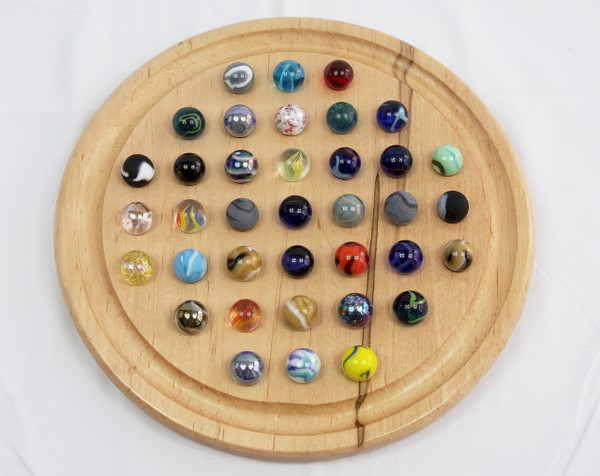 A Round Marble Solitaire board in ambrosia/wormy maple with the marbles in their starting positions.