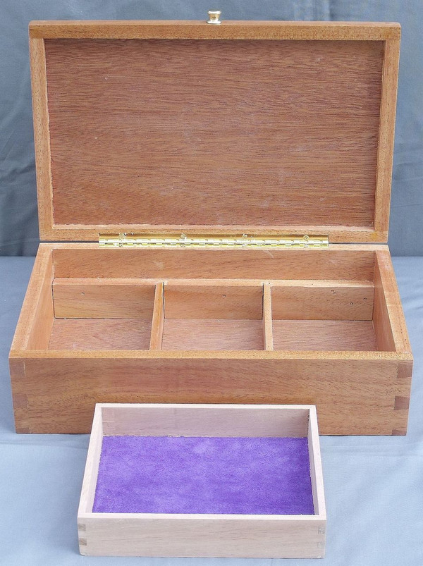 The open box with the sliding insert in front showing the divided lower compartment and the brass hinge.