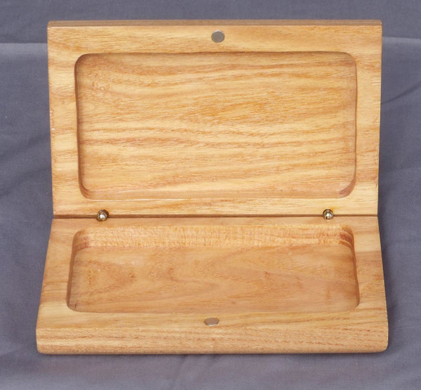 The open clamshell box showing the interior of the box, the magnets that hold it closed, and the hinges.