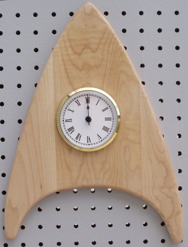The curly maple wedge clock with the point up.