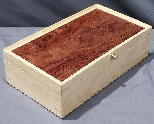 The maple and bubinga keepsake box showing the splines, brass knob, maple front and side, and bubinga top.