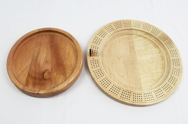 The board with the top removed showing the underside of the mahogany top and the top of the curly maple bottom.