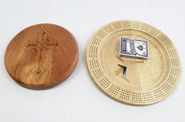 The board with the top removed showing the cards and pegs in the center storage section.