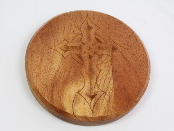 A close-up of the mahogany top with the gothic cross carving.
