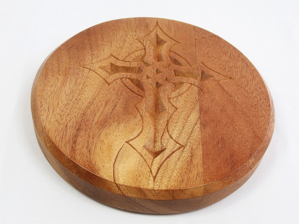 A close-up of the mahogany top with the gothic cross carving.