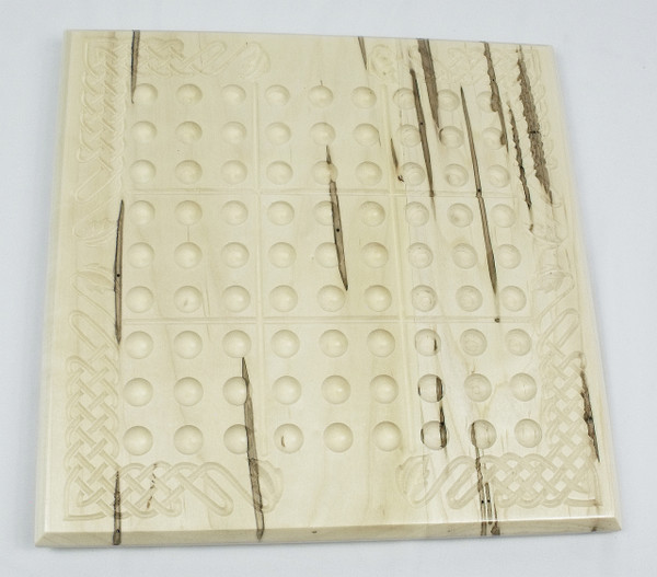 The Sudoku board without the marbles, showing the unique markings that are common to ambrosia maple