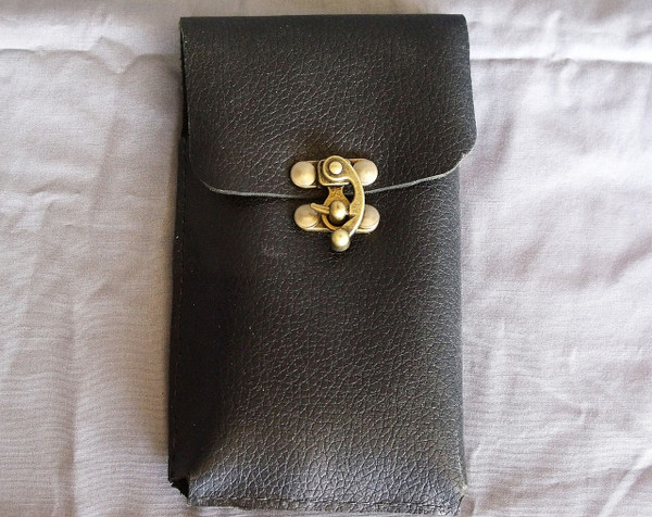 The front of the leather phone holster showing the clasp that holds  the flap closed.